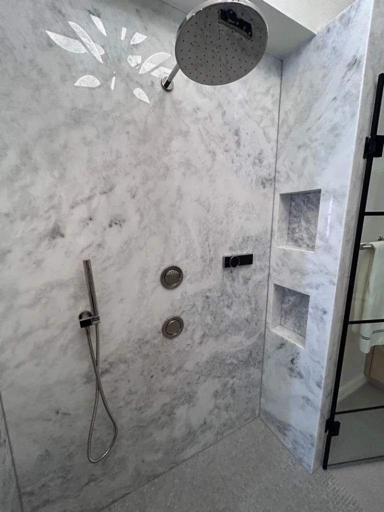 Vanity with triple-panel mirror, LED strips, and marble countertop