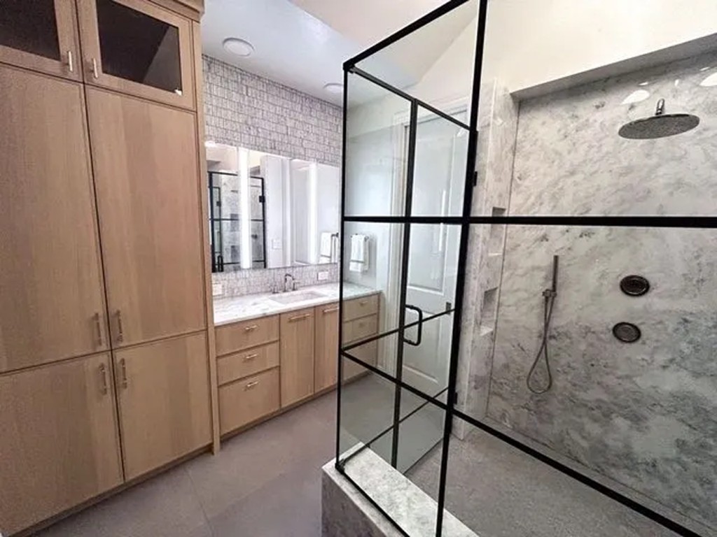 Marble shower corner with digital control panel and storage niches