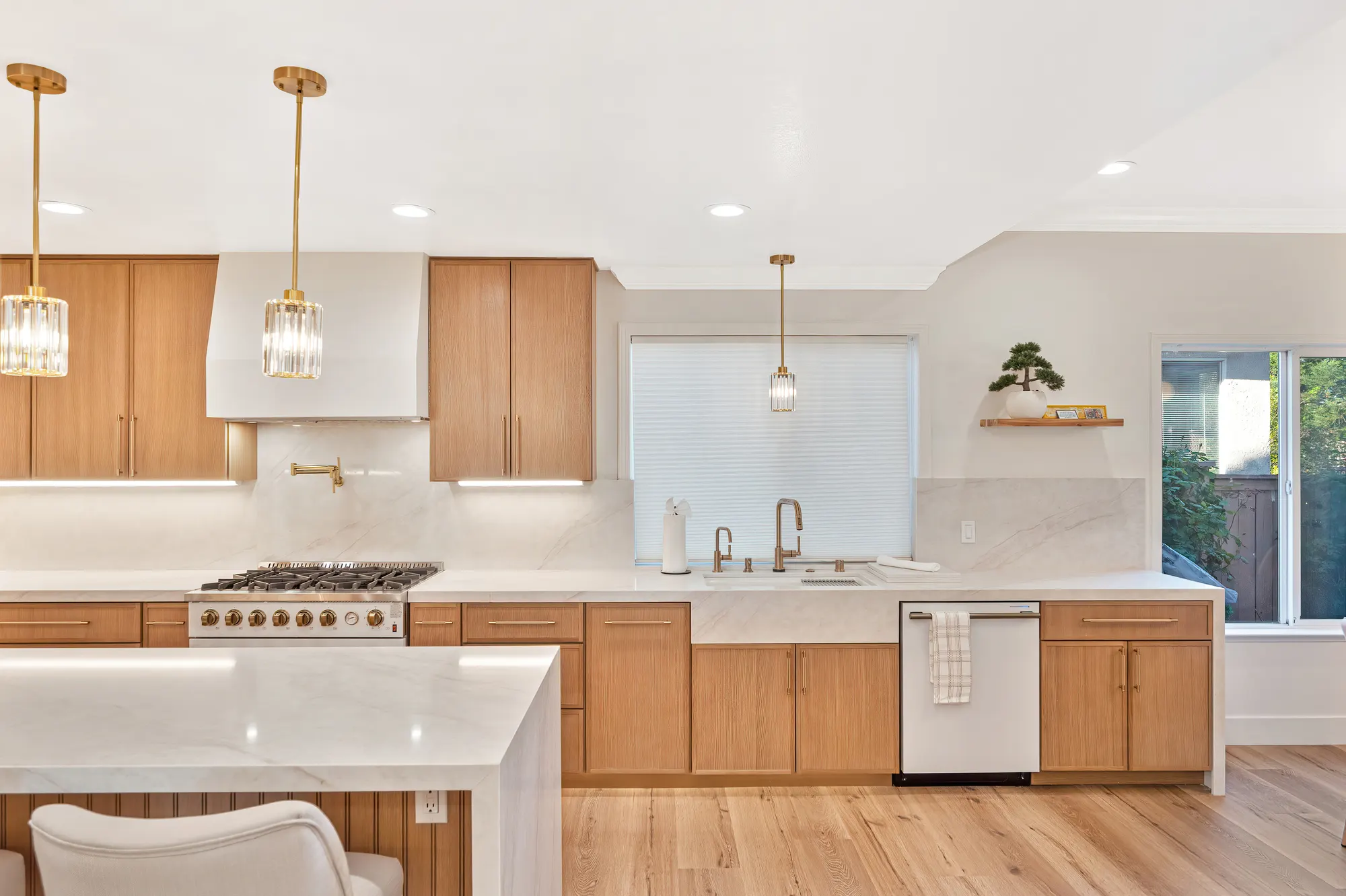 Kitchen range and marble backsplash with gold fixtures