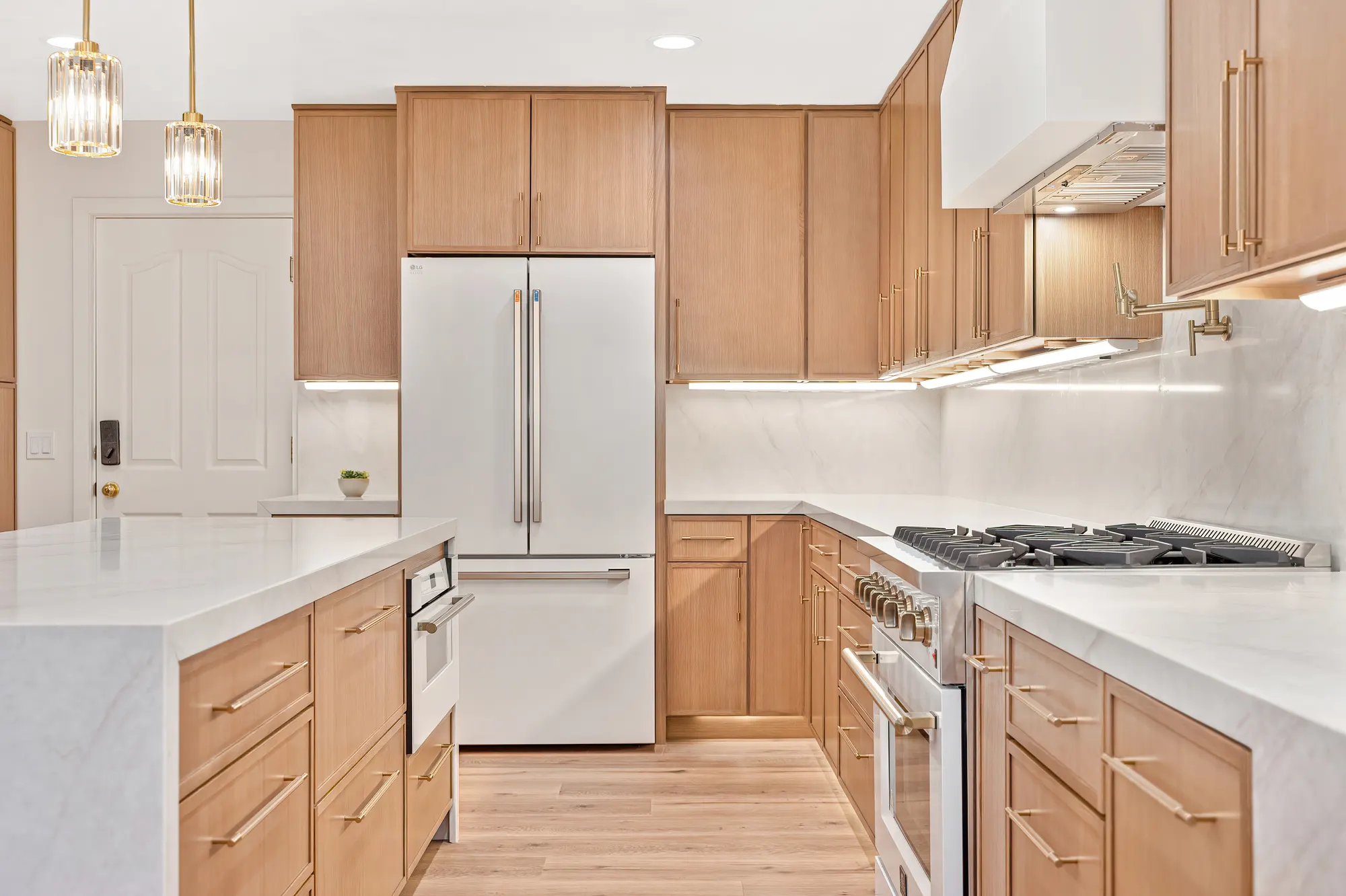 Custom oak cabinetry and marble waterfall counter detail