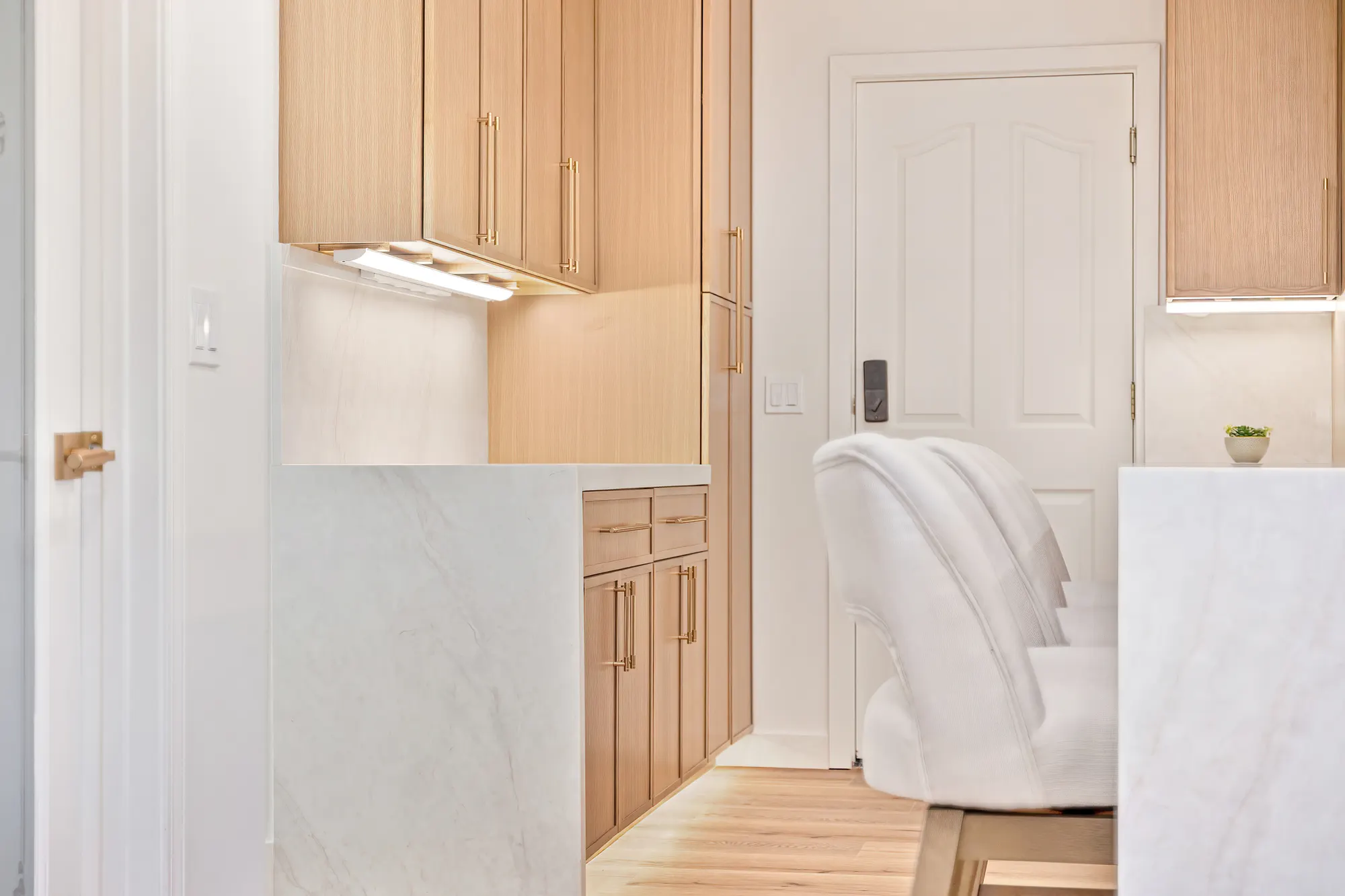 Custom oak cabinetry and marble waterfall counter detail