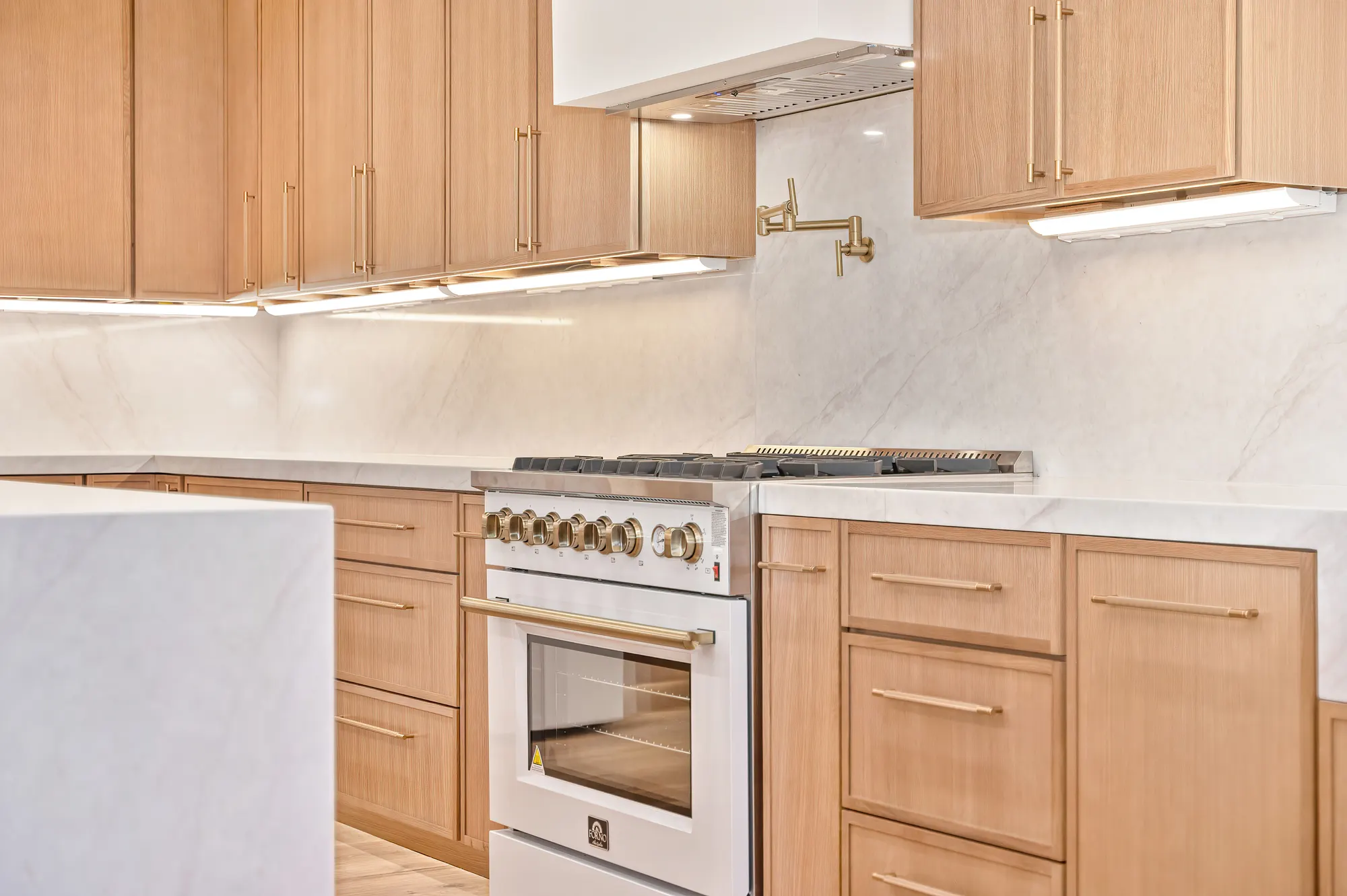 Custom oak cabinetry and marble waterfall counter detail