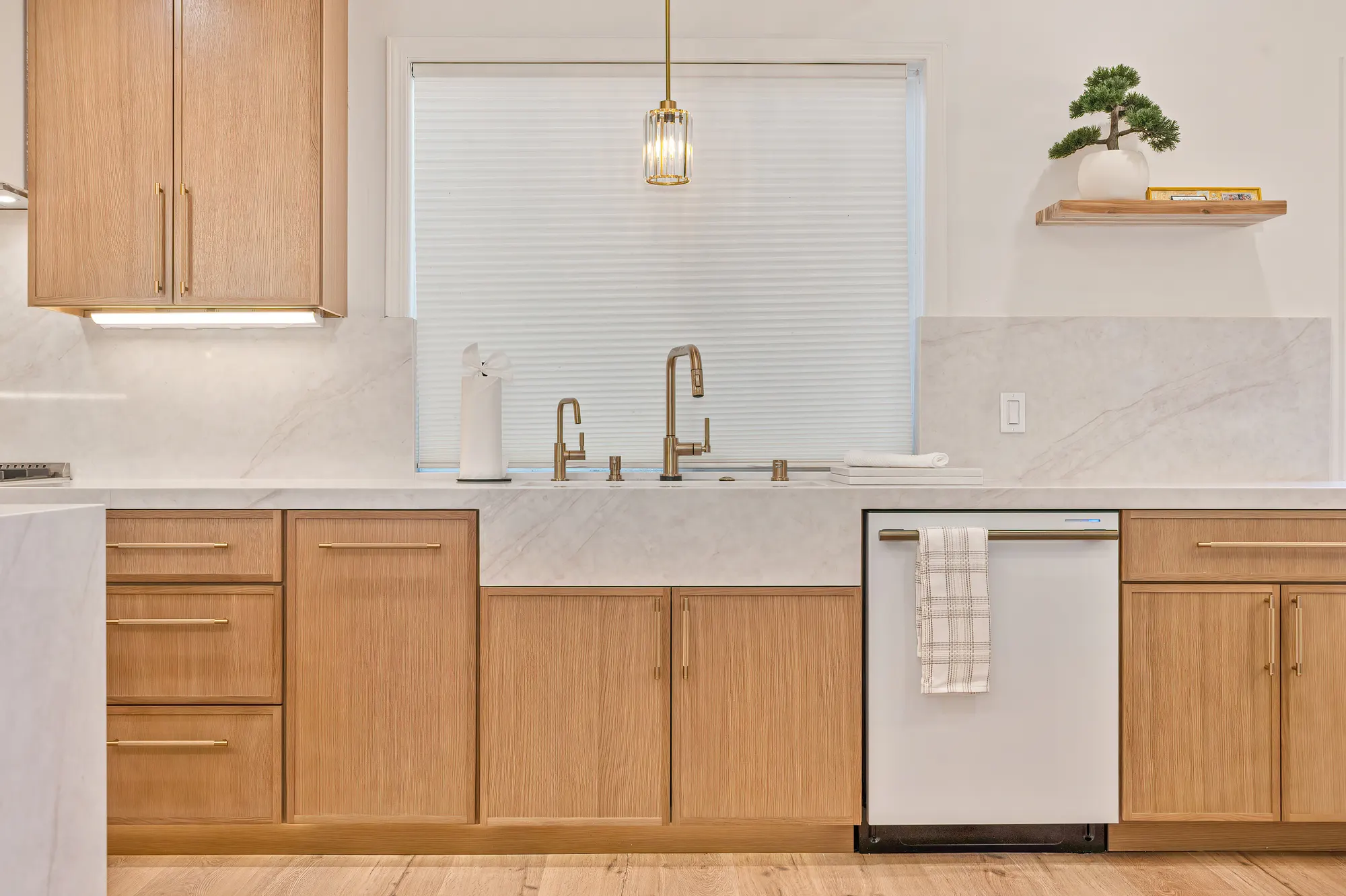 Custom oak cabinetry and marble waterfall counter detail