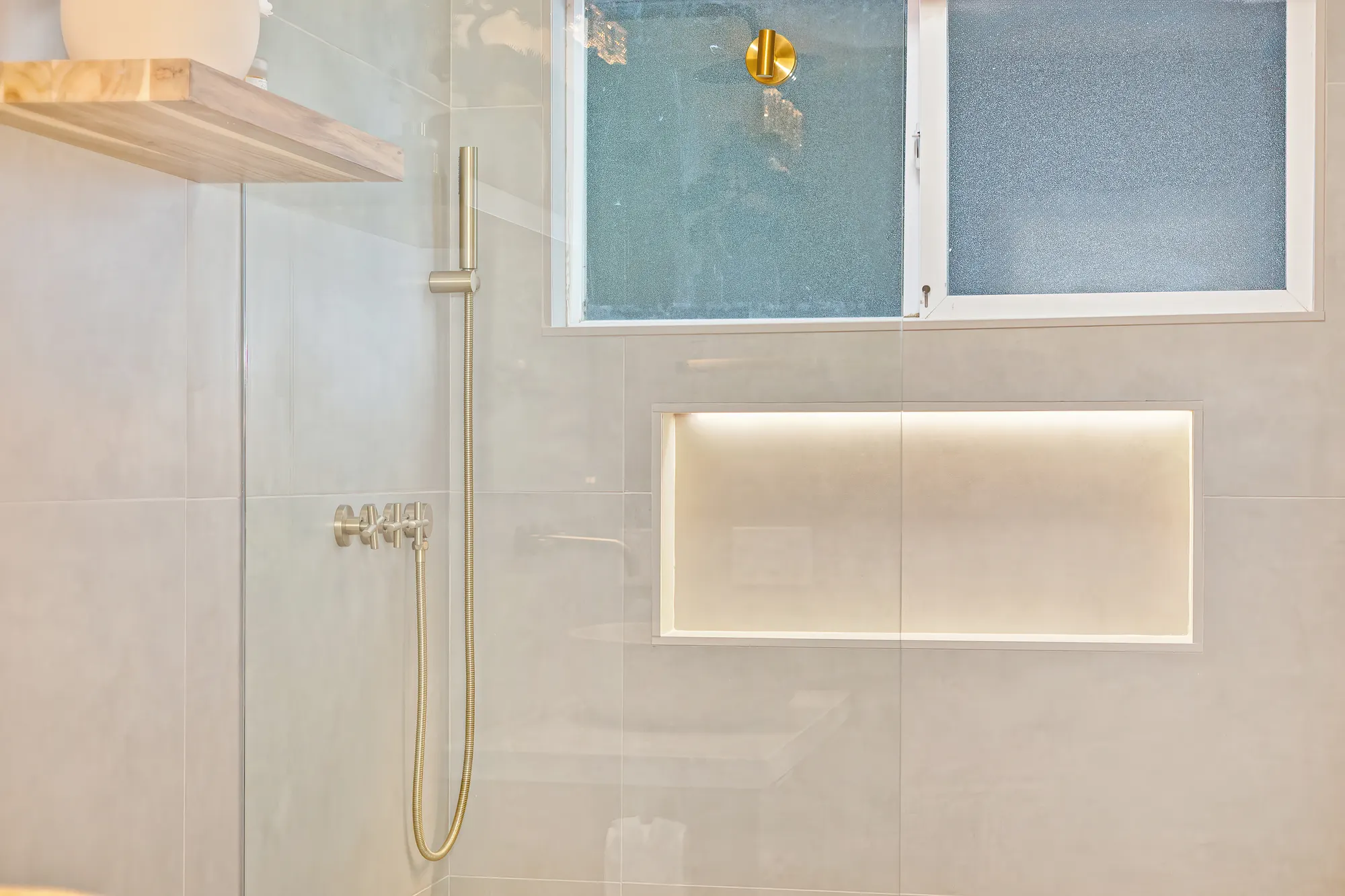 Bathroom vanity with natural stone vessel sink and gold fixtures