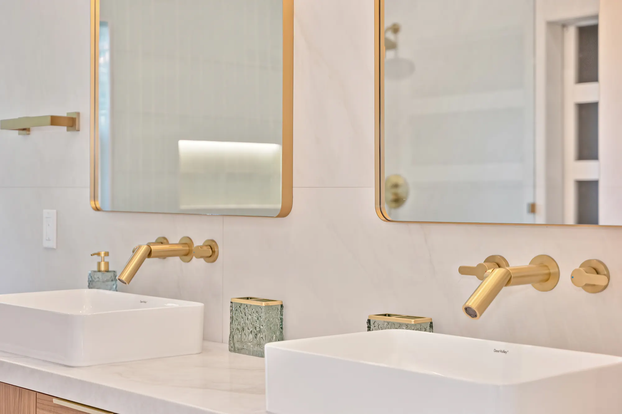 Bathroom vanity with natural stone vessel sink and gold fixtures