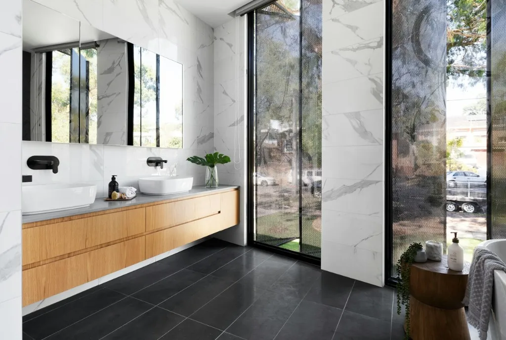 Luxury bathroom with vanity lighting and neutral tile finishes